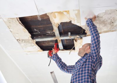 Man,Repairing,Collapsed,Ceiling.,Ceiling,Panels,Damaged,Huge,Hole,In
